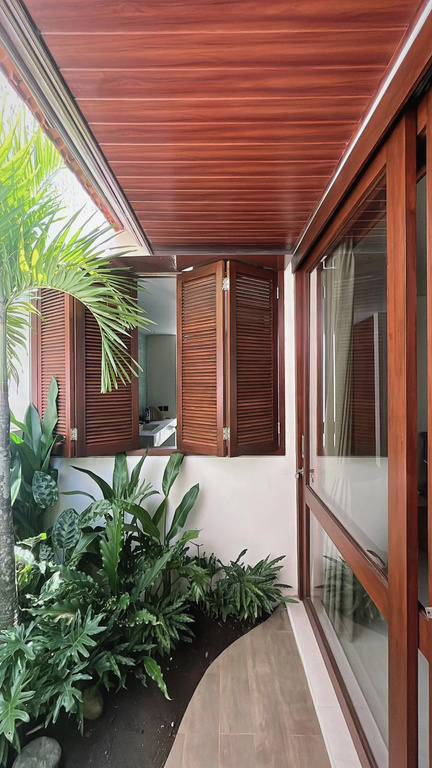 GS House timber shutters and tropical planting.